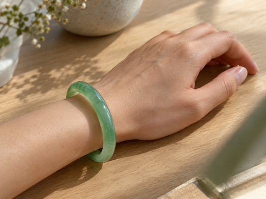 Jade bangle worn on the left wrist, the side traditionally favoured in Chinese custom